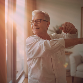 Senior moving comfortably after red light therapy for osteoarthritis session