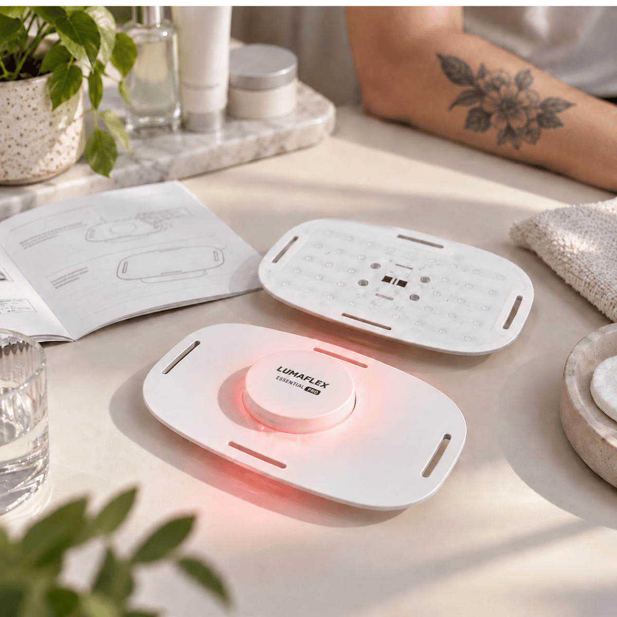 Portable red and near-infrared light therapy device shown with usage instructions near healed tattooed skin