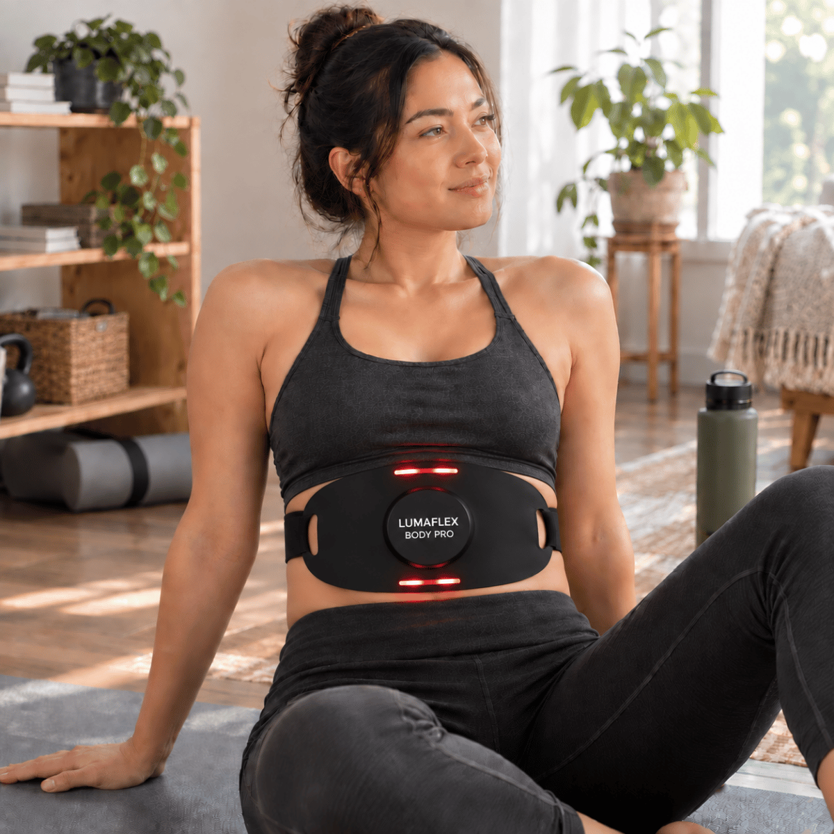 Woman using a red light therapy device during a relaxed home recovery session