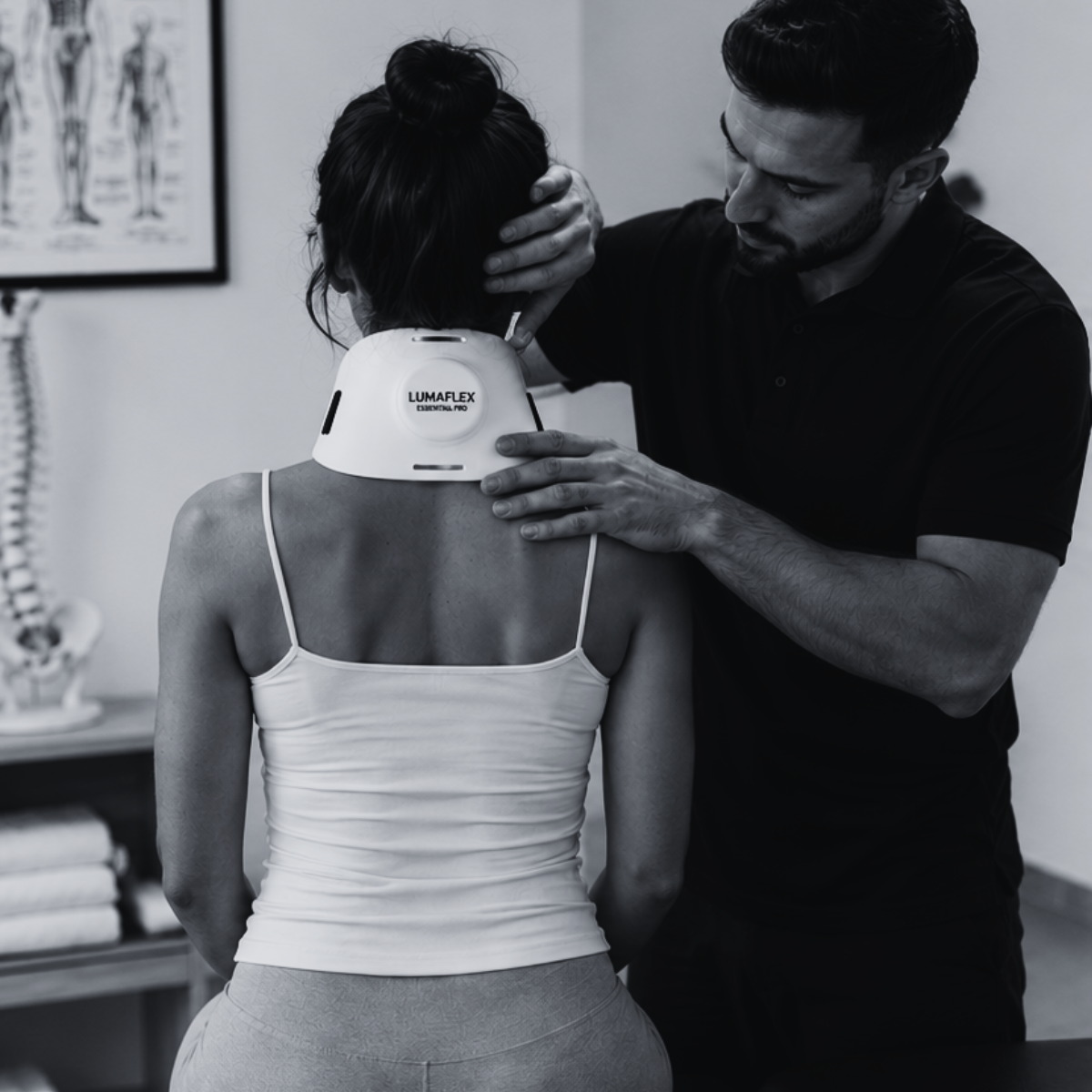 Chiropractor performing a spinal adjustment as part of a treatment plan that includes red light therapy