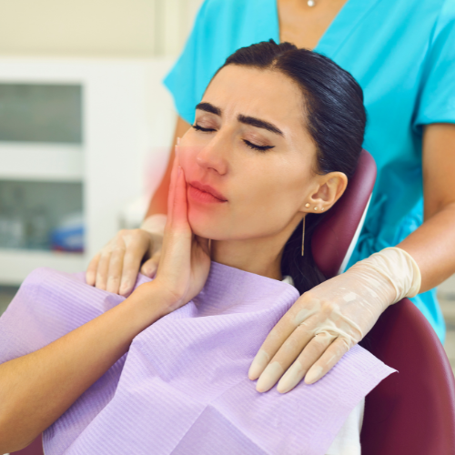 Woman experiencing ear and jaw pain after tooth extraction